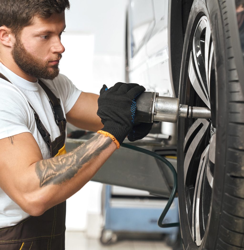 brutal-mechanic-fixing-hubcap-car-wheel-scaled-1-1-1-1-1-1.jpg
