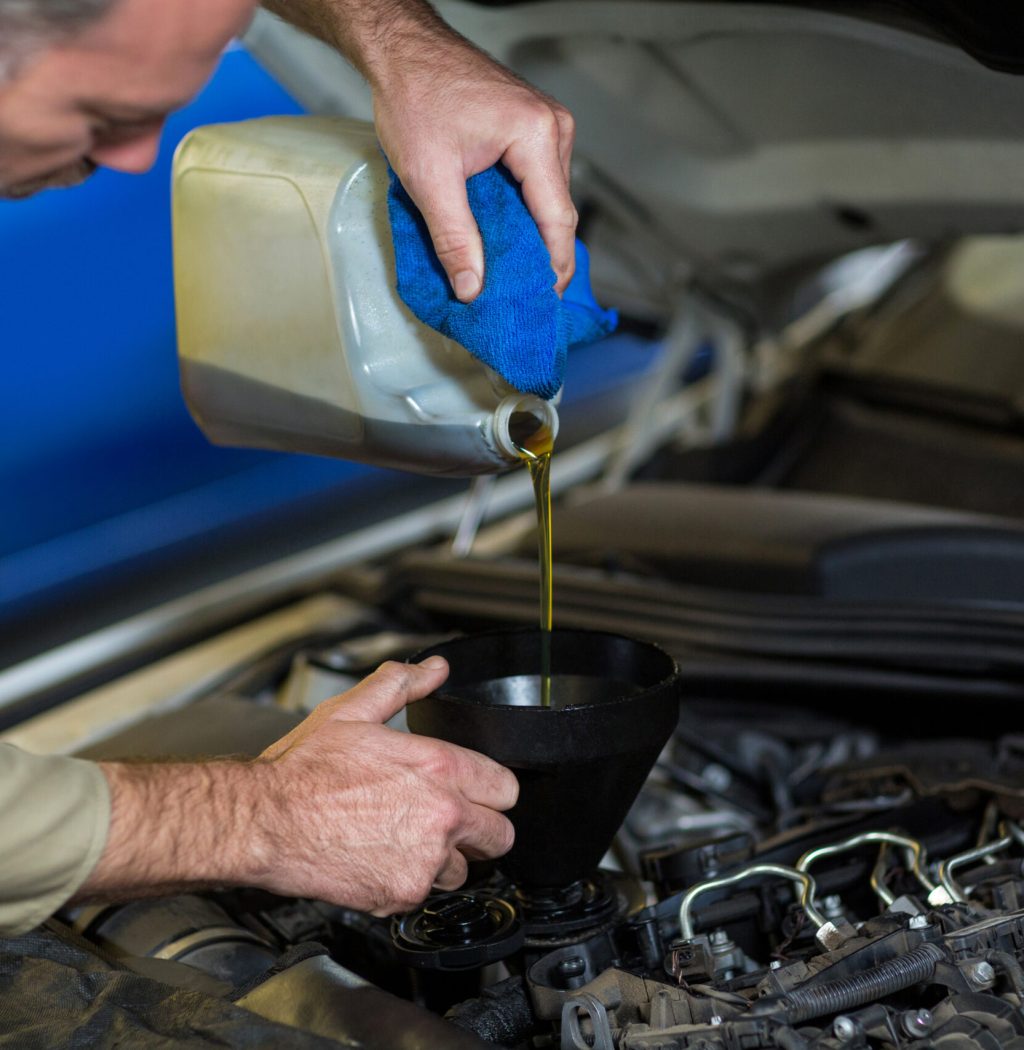 mechanic-pouring-oil-into-car-engine-scaled-1-1-1-1-1-1.jpg